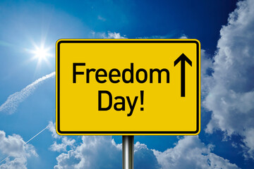 German road sign with Freedom Day ahead with blue sunny sky background