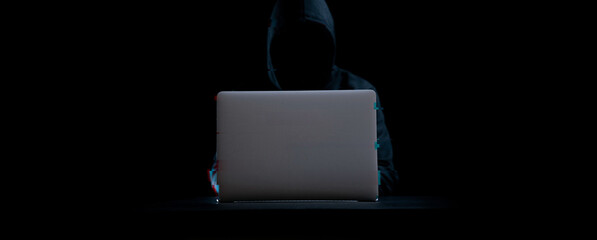 Hacker attack cyber security. Digital laptop in hacker man hand isolated on black. Blurred Internet web hack technology with glitch effect. Login and password, cybersecurity banner concept.