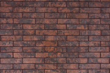 Wall, wallpaper made of dark brown brick. Background, brick wall texture. 