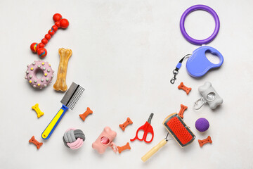 Set of pet care accessories and snacks on light background