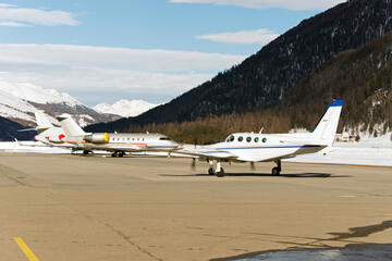 Fototapeta na wymiar Private jets and aircrafts at the airport of Engadine St Moritz