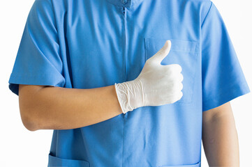 A surgeon wearing a blue uniform stands with his thumbs up. on a white background.