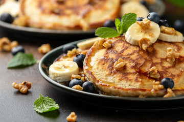 American pancakes with banana, blueberry, walnut and honey. Healthy morning breakfast