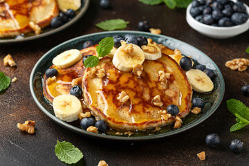American pancakes with banana, blueberry, walnut and honey. Healthy morning breakfast