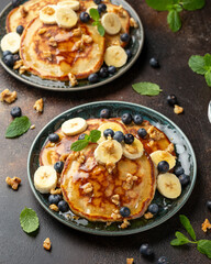 American pancakes with banana, blueberry, walnut and honey. Healthy morning breakfast