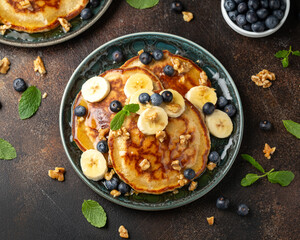 American pancakes with banana, blueberry, walnut and honey. Healthy morning breakfast