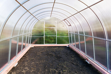 Greenhouse made of polycarbonate on a metal frame, inside view.