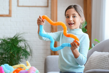Little girl playing with Pop Tubes at home