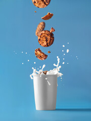 Glass of milk and splash. With cookies levitation. Milk and cookies. Food photo poster blue...