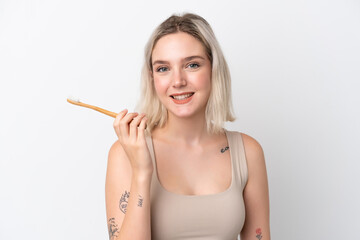 Young caucasian woman isolated on white background with a toothbrush