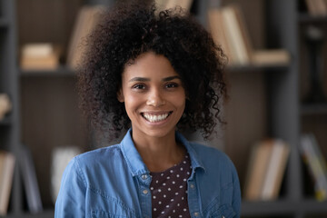 Head shot portrait of happy millennial confident African American businesswoman worker employee looking at camera, profile photo for professional social network, corporate career, female leadership.