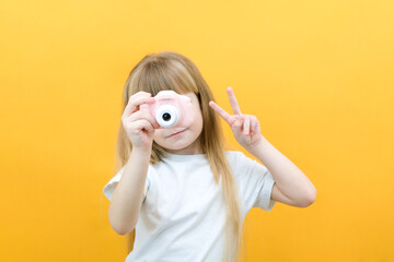 real happiness. hobby or career. beginner photographer with a camera. childhood. girl takes a...