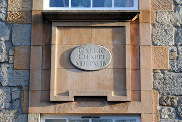 Detail of Carved Stone Plaque with Roman Numerals on Ancient Chapel 