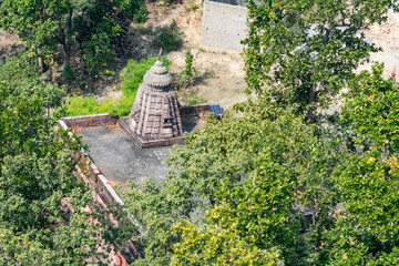 Lord shiva temple at top of a mountain which is situated at under greenery forest in odisha,india looking awesome from mountain peak. - 488342534