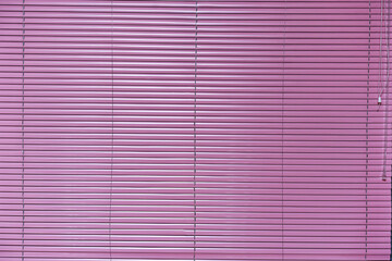 Lilac colored steel window shutter is closed front view. Protection from sun light at summer hot...