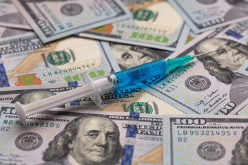Syringe on 100 dollar banknote