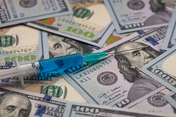 Syringe on 100 dollar banknote