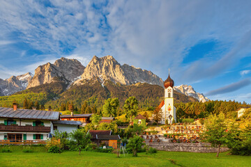 Zugspitze peak and Alps mountain range with small church, Garmisch Partenkirchen, Germany