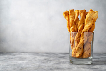 Cheese breadsticks with cheese in glass, snack food. Copy space. - obrazy, fototapety, plakaty