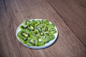 diced kiwifruit in a white bowl on a wooden table