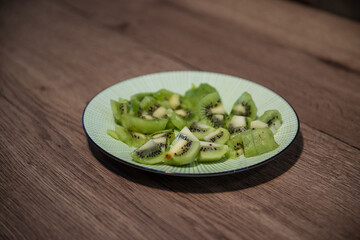 diced kiwifruit in a white bowl on a wooden table