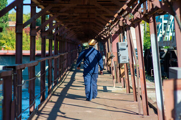 Fototapeta premium Shipyard worker in overalls and helmet