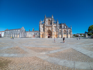 Obraz premium Batalha, Portugal, August 21, 2021: The Monastery of Santa Maria da Vitória. The Monastery of Batalha is one of the most fascinating Gothic monuments of the Iberian Peninsula.