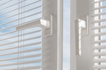 Open window. PVC plastic. Louver blinds.