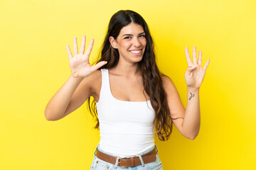 Young caucasian woman isolated on yellow background counting nine with fingers