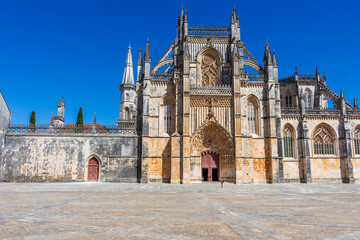 Fototapeta na wymiar Batalha, Portugal, August 21, 2021: The Monastery of Santa Maria da Vitória. The Monastery of Batalha is one of the most fascinating Gothic monuments of the Iberian Peninsula.