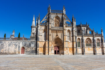 Fototapeta na wymiar Batalha, Portugal, August 21, 2021: The Monastery of Santa Maria da Vitória. The Monastery of Batalha is one of the most fascinating Gothic monuments of the Iberian Peninsula.