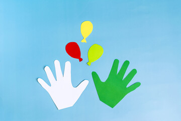 Abstract background colored paper palms and multicolored balls on a blue background top view.