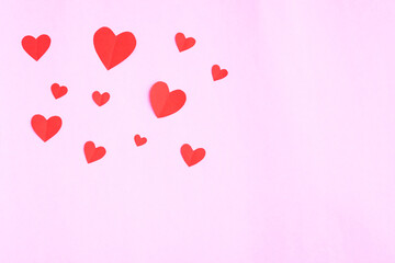 Red hearts papercut on pink background