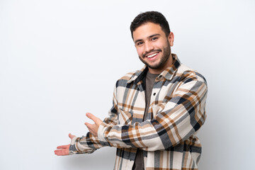 Young Brazilian man isolated on white background extending hands to the side for inviting to come