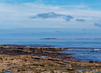 The View across the Tumbler Rocks at Low Tide at Seahouses and across to the Inner Farne Islands...