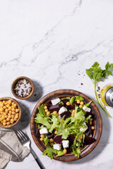 Healthy spring salad beet with spinach, cheese feta and chickpeas on a marble tabletop. Top view flat lay. Copy space.