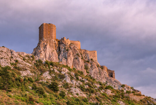 A famous landmark Queribus Castle ruins in south of France Pyrenees Mountains sunset view
