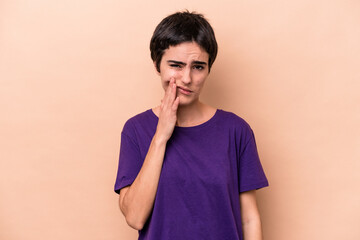 Young caucasian woman isolated on beige background having a strong teeth pain, molar ache.