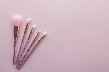 many makeup brush on pink background 