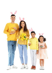 Fototapeta premium Happy family with Easter eggs, cake, rabbit and tulips on white background