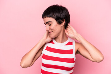 Young caucasian woman isolated on pink background feeling confident, with hands behind the head.