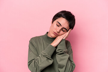 Young caucasian woman isolated on pink background yawning showing a tired gesture covering mouth with hand.