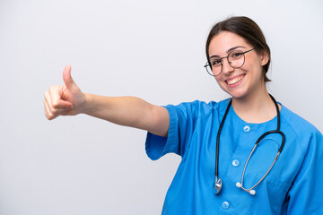 surgeon doctor woman holding tools isolated on white background giving a thumbs up gesture