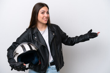 Young girl with a motorcycle helmet isolated on white background extending hands to the side for inviting to come