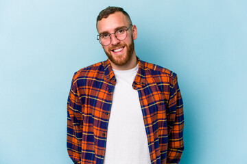Fototapeta premium Young caucasian man isolated on blue background happy, smiling and cheerful.