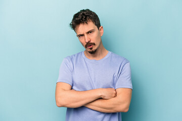 Fototapeta premium Young caucasian man isolated on blue background who is bored, fatigued and need a relax day.