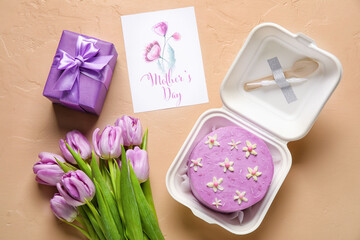 Plastic lunch box with tasty bento cake, greeting card and flowers on color background