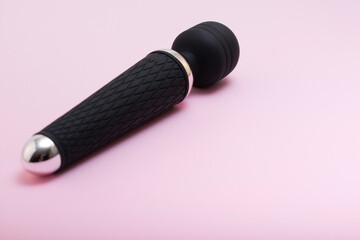Adult sex toy, designer dildo vibrator isolated on pink background. Sex gadgets and devices for masturbation.A place for your text.