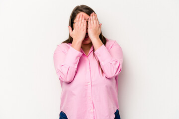 Young caucasian overweight woman isolated on white background having fun covering half of face with palm.