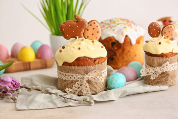 Tasty Easter cakes decorated with cookies on table